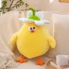 A cute yellow chick doll with white flowers on its head, green stems for decoration, orange PAWS and a white plush background is a children's gift details Picture